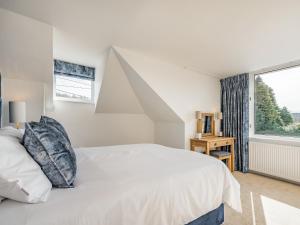 a bedroom with a white bed and a large window at Brooksyde,Kippford in Kippford