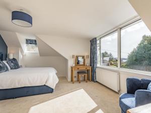 a bedroom with a bed and a large window at Brooksyde,Kippford in Kippford