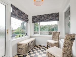 a room with two chairs and two windows at Brooksyde,Kippford in Kippford