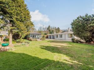 a yard with a house and a tree at Brooksyde,Kippford in Kippford +23 photos
