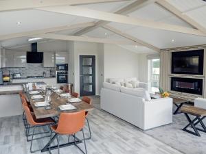 a dining room and living room with a table and chairs at Trincomalee Lodge - Ukc4057 in Nunthorpe