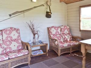 two chairs and a table on a porch at Copper House - 18435 in Bempton