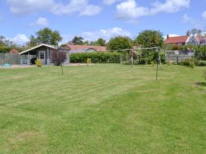 a large yard with two swings in the grass at Copper House - 18435 in Bempton