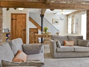 a living room with two couches and a table at Copper House - 18435 in Bempton +7 photos