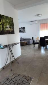 a living room with a painting on the wall at Casa Focșani in Cîmpineanca +16 photos