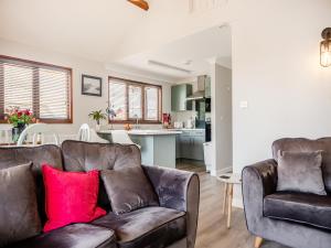 a living room with a couch and a kitchen at River Rest-B6863 in Brundall