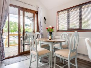 a dining room with a table and chairs at River Rest-B6863 in Brundall