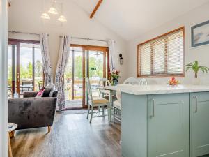 a kitchen and living room with a table and chairs at River Rest-B6863 in Brundall +11 photos