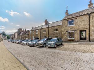 a row of cars parked in front of a brick building at Frenchgate Mews in Richmond