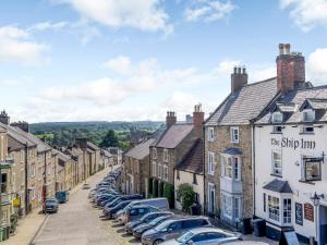 a row of houses and cars parked in a street at Frenchgate Mews in Richmond +19 photos