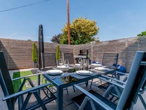 a blue table and chairs on a patio at Nursery Mews in Whitstable