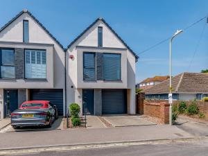 a red car parked in front of a house at Nursery Mews in Whitstable