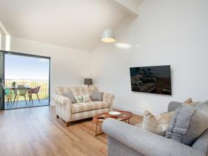 a living room with two chairs and a table at Bluebell-Uk34613 in Nether Stowey