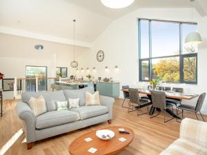 a living room with a couch and a table at Bluebell-Uk34613 in Nether Stowey