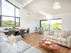 a living room with two couches and a table at Bluebell-Uk34613 in Nether Stowey