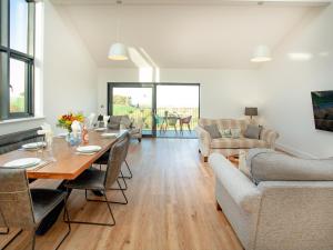 a living room with a table and a couch at Bluebell-Uk34613 in Nether Stowey