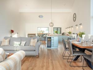 a living room with a couch and a table at Bluebell-Uk34613 in Nether Stowey +23 photos