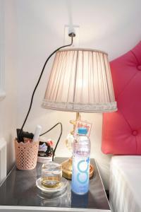a table with a bottle of water and a lamp at Nhà Nghỉ Thuận Phát in Làng Chang