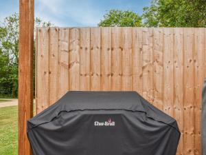 a fence with a black cover on top of a table at Dodds Barn in Fersfield
