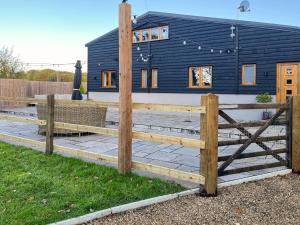 a wooden fence in front of a house at Dodds Barn in Fersfield