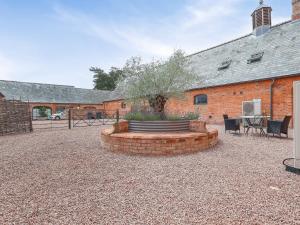 a courtyard with a brick building and a table and chairs at Plough Share in Gloucester