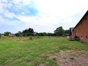 an empty field next to a brick building at Plough Share in Gloucester