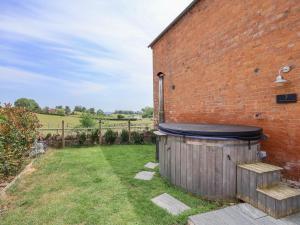 a wooden tub sitting next to a brick building at Plough Share in Gloucester +16 photos