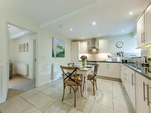 a kitchen with a table and chairs in it at Fox Cover - Uk49892 in Preston