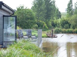a couple of chairs sitting in the middle of a flooded house at Kingfisher Lodge - Uk33889 in Cullompton