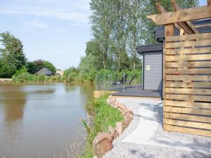 a building next to a body of water at Kingfisher Lodge - Uk33889 in Cullompton +15 photos