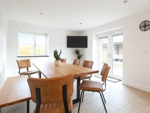 a dining room with a wooden table and chairs at Chancery View in Ross on Wye