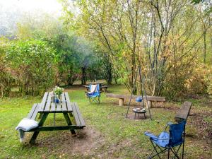 a picnic table and two chairs and a bench in a park at Uk45543-The Threshing Barn in Sticklepath +33 photos