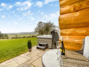 a patio with a table and a hot tub at Hope Hideaway in Buttington