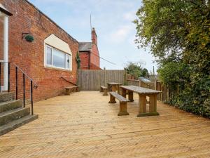 a patio with benches and a brick building at Brook House - Uk43013 in Berkeley