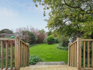 a wooden gate leading to a garden with a yard at Brook House - Uk43013 in Berkeley