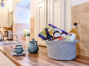 a basket of beer and snacks on a kitchen counter at Ghyll View in Gunnerside