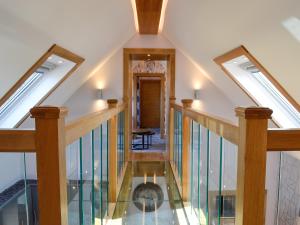 an attic hallway with skylights and glass floors at Hillend Stables in Dalry