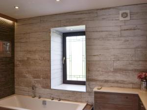 a bathroom with a large mirror and a tub at Hillend Stables in Dalry