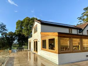 a house with large windows on a patio at Quabbs Head Cottage in Mathon
