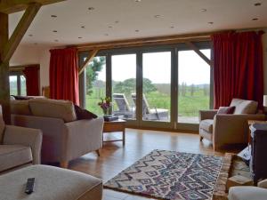 a living room with furniture and a large window at Henry-Oscar House in Winchelsea +27 photos