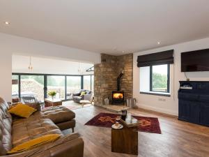 a living room with a couch and a fireplace at Moorgate Cottage - Ukc3380 in Kelbrook