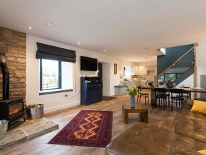 a living room with a couch and a fireplace at Moorgate Cottage - Ukc3380 in Kelbrook