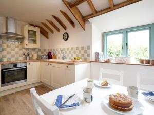 a kitchen with a table with a cake on it at Fort View - Uk32692 in Horton