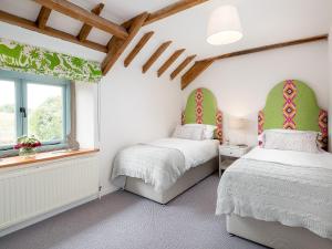 a bedroom with two beds and a window at Fort View - Uk32692 in Horton +3 photos