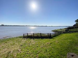 a view of a body of water with a fence at Bank House Apartment in Newnham