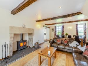 a living room with a couch and a fireplace at Warth House - Uk44209 in Ingleton