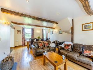 a living room with leather furniture and a table at Warth House - Uk44209 in Ingleton