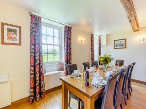 a dining room with a table and chairs and a window at Warth House - Uk44209 in Ingleton