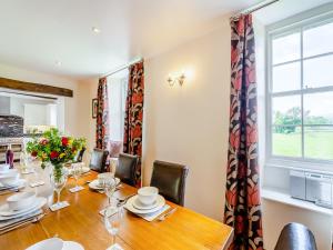 a dining room with a table and a window at Warth House - Uk44209 in Ingleton +27 photos