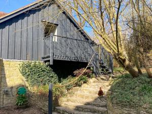 a barn with two chickens standing outside of it at Larkhams Loft in Teffont Magna